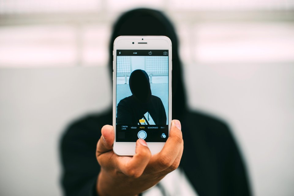 Silhouette Of Person Taking Selfie photo