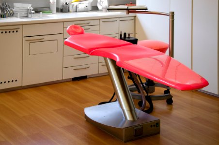 Gray Metal Framed Red Dental Treatment Chair photo