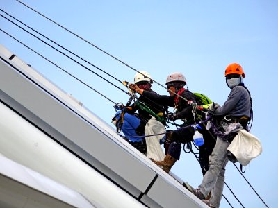 Workers On Safety Harnesses