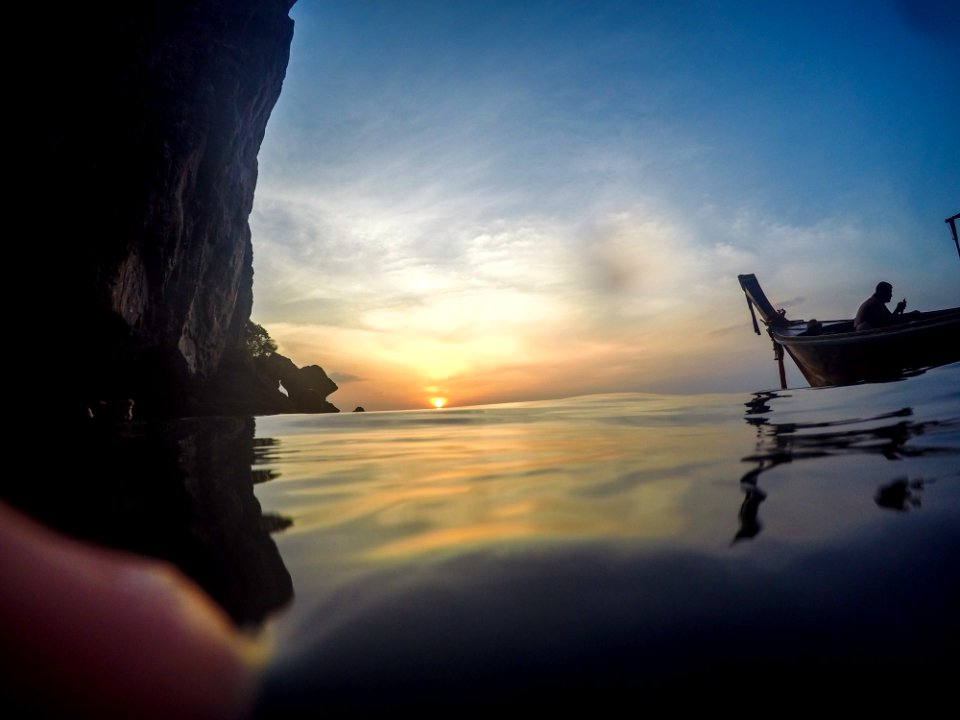 Silhouette Of Man Riding Boat