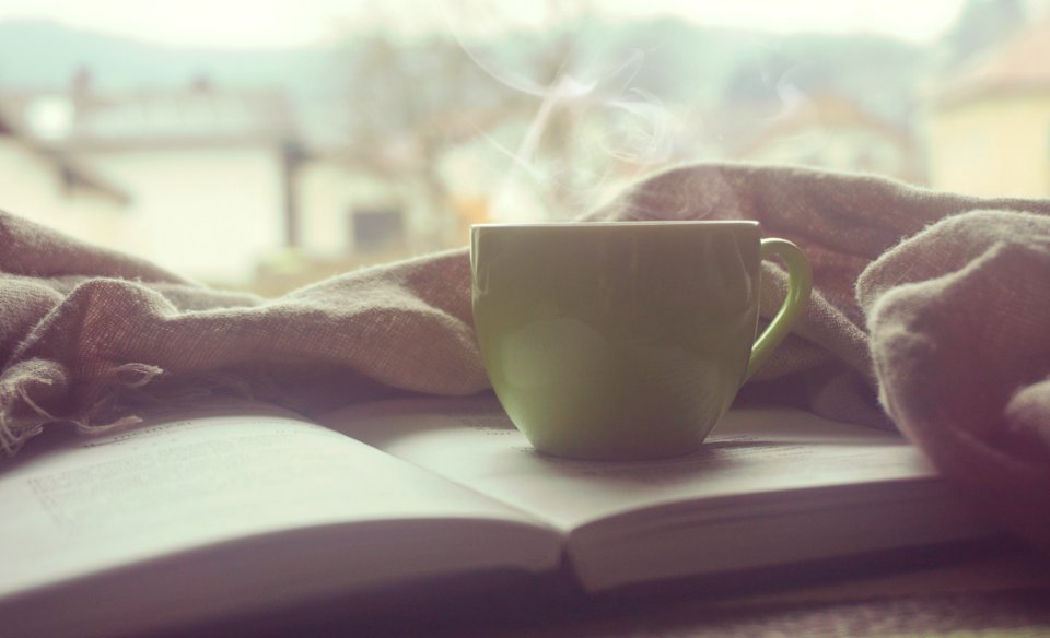 White Hot Mug On Book Near Linen