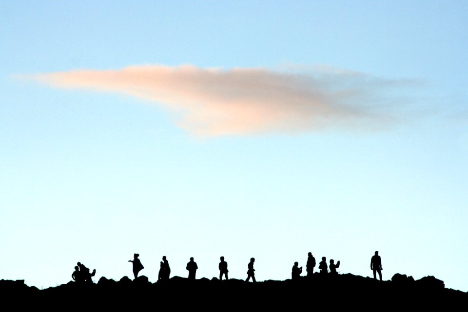 Silhouettes Of Folk At Hill Top Gathering