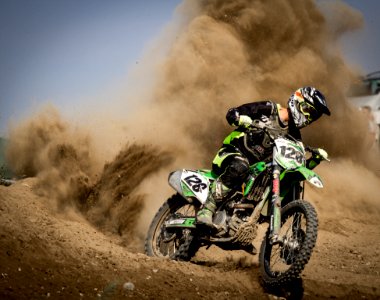 Rider Riding Green Motocross Dirt Bike photo