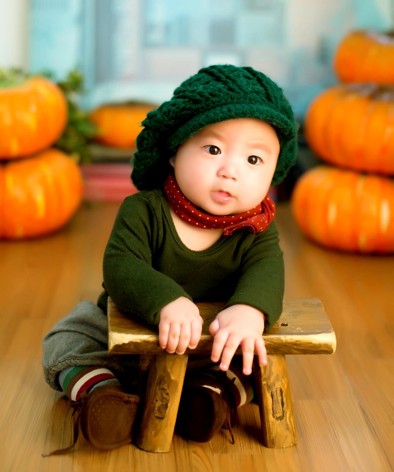 Asian Child Leaning On Stool