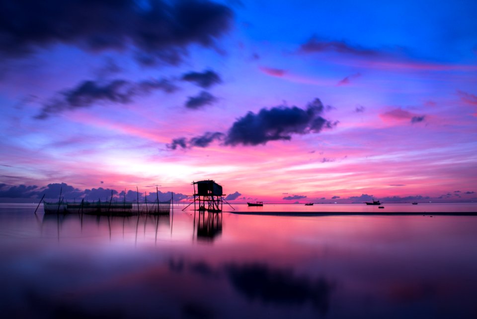 Tropical Stilt Houses In Sea At Sunset