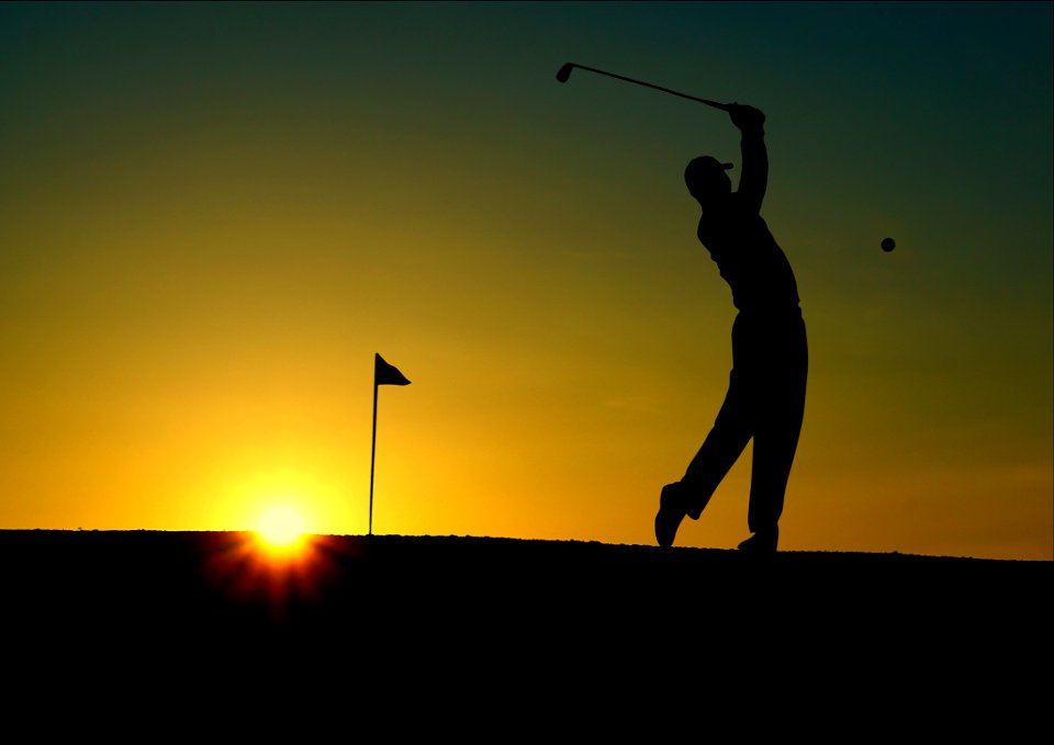 Silhouette Of Man Playing Golf During Sunset