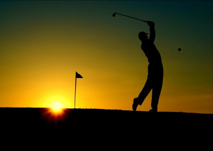 Silhouette Of Man Playing Golf During Sunset photo