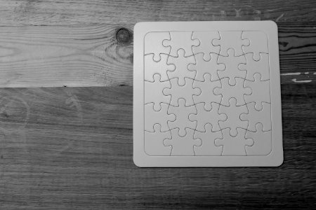Gray Scale Photo Of Jigsaw Puzzle photo