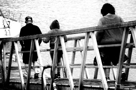 3 Person Walking On Bridge Black And White Photo photo