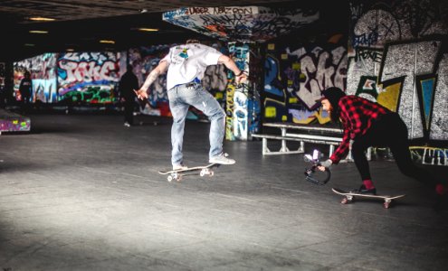 Man In White Shirt On Black Skateboard Doing Tricks photo