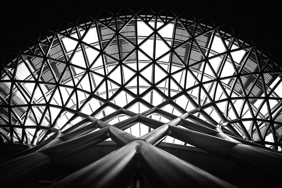 Low Angle Photography Of Metal Building On Grayscale