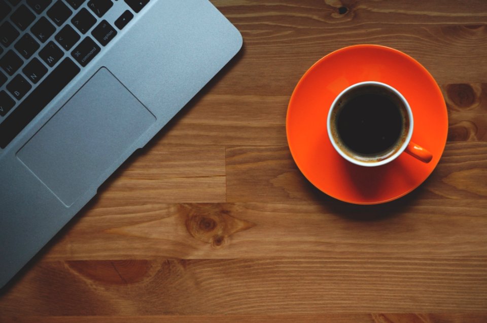Black Coffee Filled In White Ceramic Mug On Orange Plate