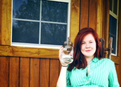 Woman In Green Button Up Collared Shirt Holding Clear Glass photo