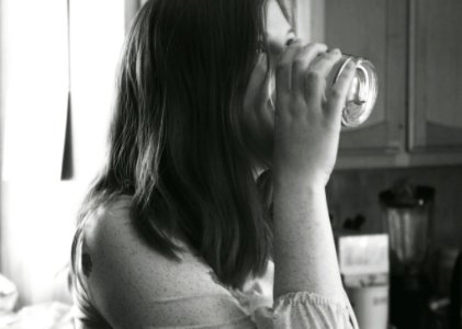 Grayscale Photo Of Lady Drinking Water photo