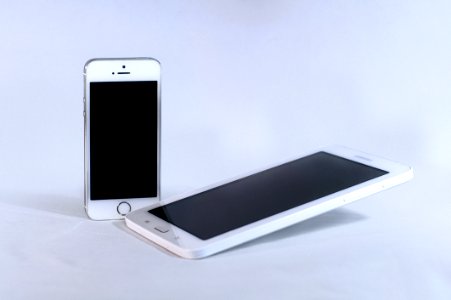 Silver Iphone 5s And White Samsung Android Smartphone photo