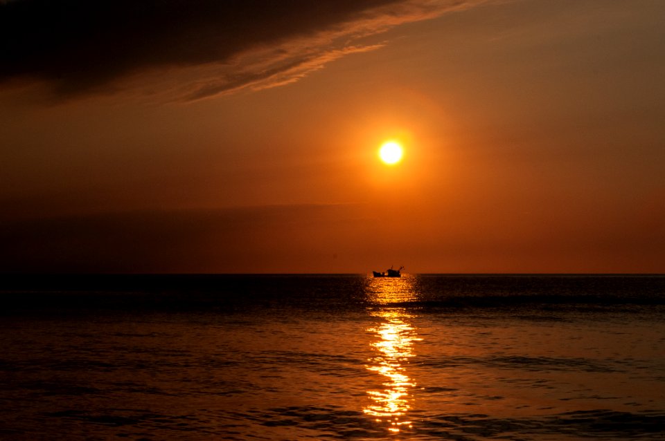 Sunset Over Boat On Water