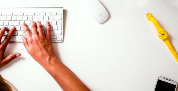 Person Typing On Keyboard At Desk