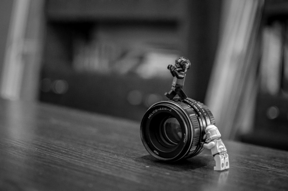 Toy Men Pushing Lens