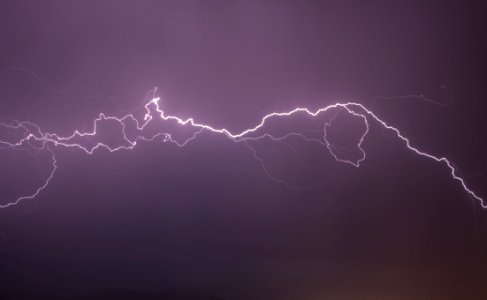 Red Lightning Flashing On Black Sky