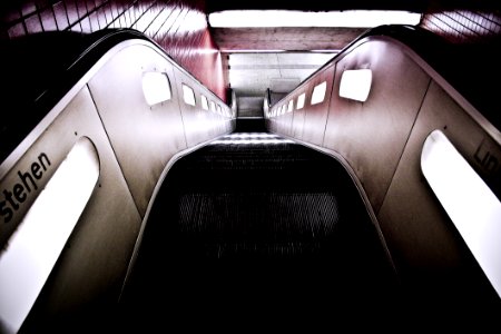 Black Escalator Near Red Wall Tiles
