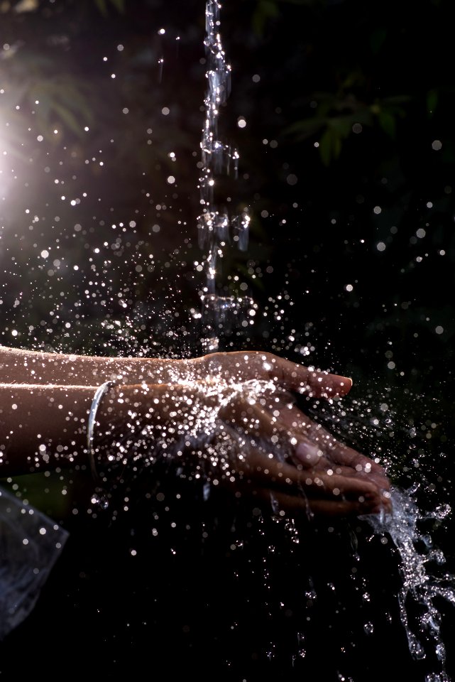 Human Hand Under Pouring Water