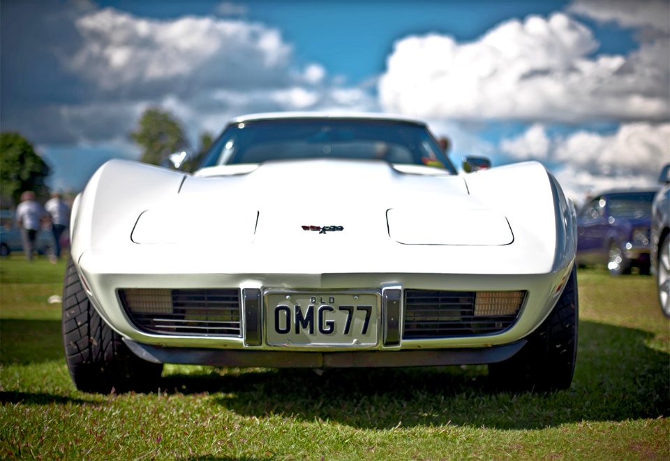 White Corvette C3 With Omg77 License Plate On Display