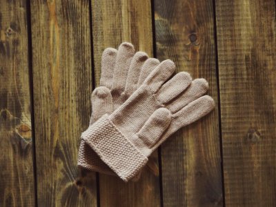 White Gloves On Brown Wooden Surface photo