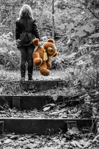 Girl In Jacket Carrying Brown Bear Plush Toy Selective Color Photo photo