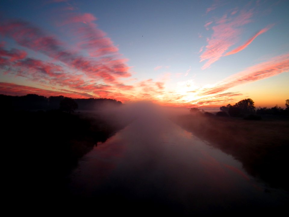 Sun Setting Over White Clouds