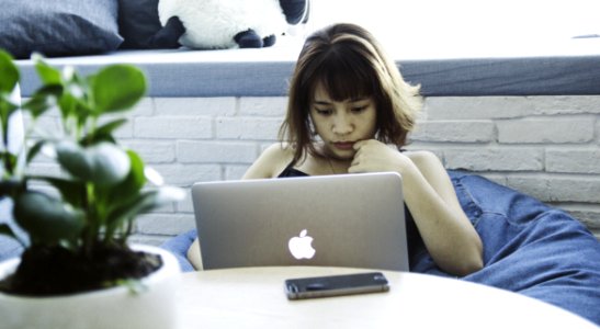 Woman In Black Tank Top Using Silver Macbook