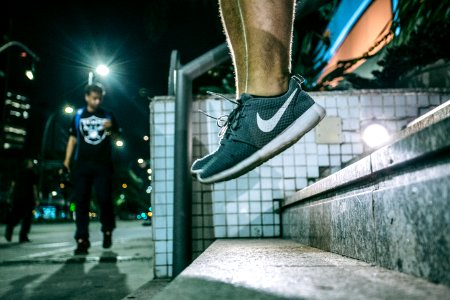 Man In Black White Nike Shoes During Nighttime