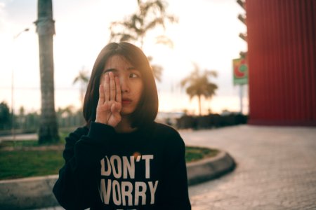 Woman Covering Her Right Eye Using Her Right Hand During Daytime photo