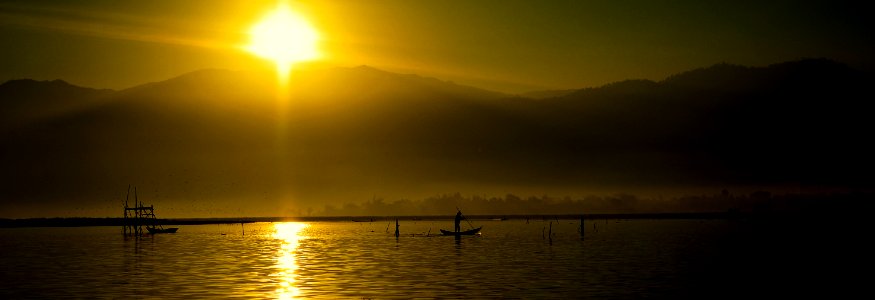 Silhouette Of People Riding Boats On Water During Daytime