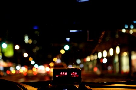 Meter Of Taxi Cab Driving Through City