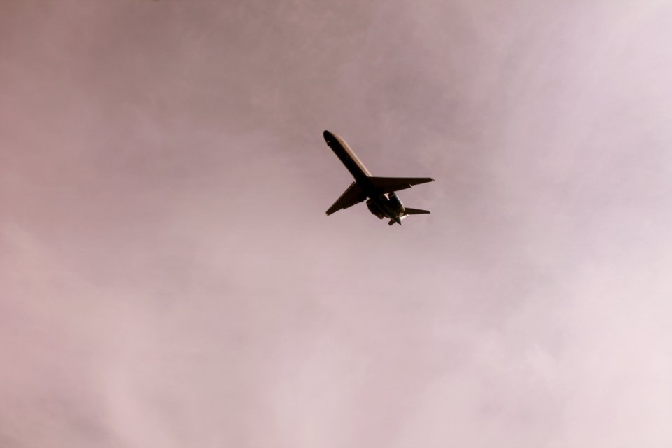 Airplane Flying In Mid Air Under Gray Clouds