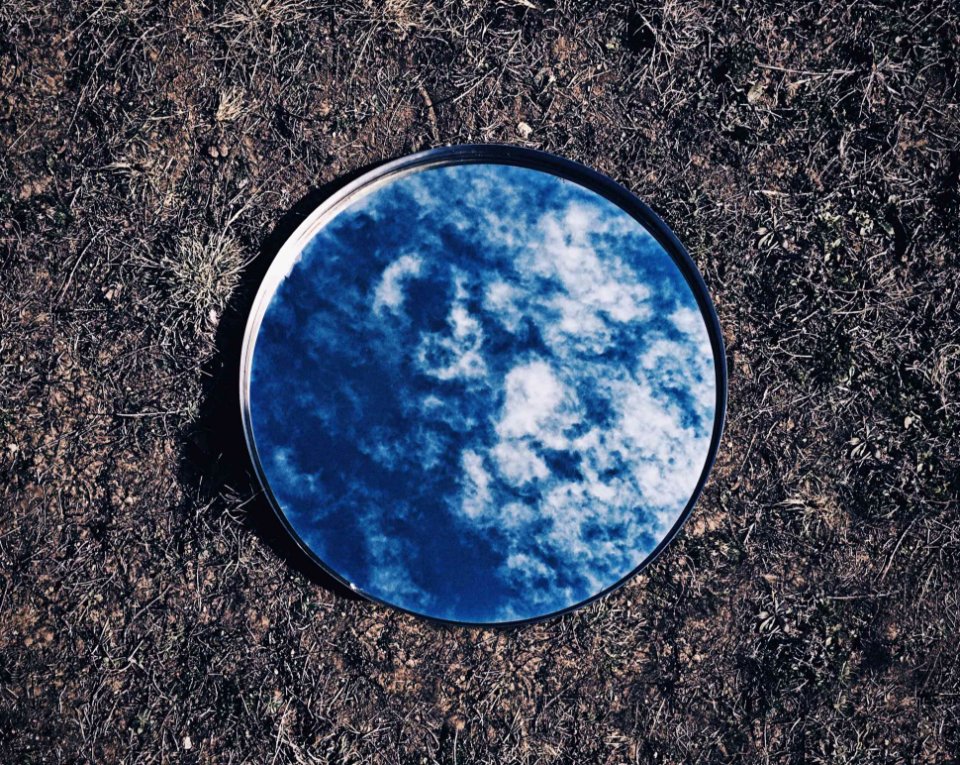 Clouds And Sky Reflected On Mirror