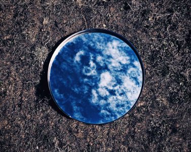 Clouds And Sky Reflected On Mirror