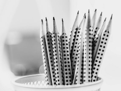 Grayscale Photography Of Pencil Inside Round Basket photo