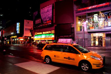 Yellow Hvc Taxi On Road During Night photo