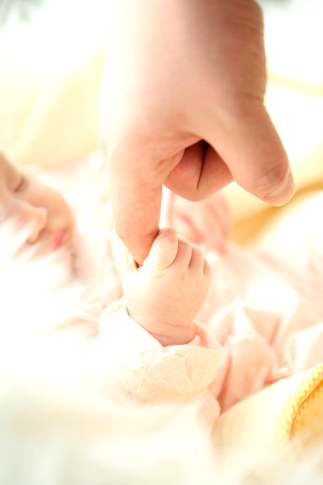 Baby Holding Persons Index Finger