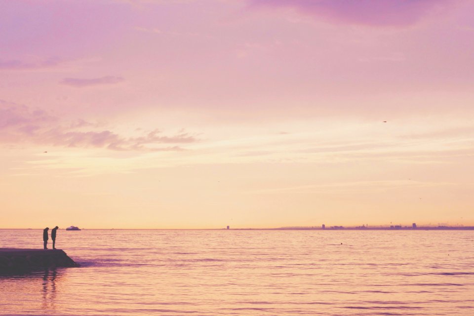 2 Person Standing On Shore Near Calm Sea