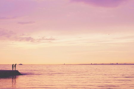 2 Person Standing On Shore Near Calm Sea photo