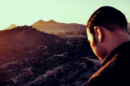 Man Overlooking Mountain Valley photo