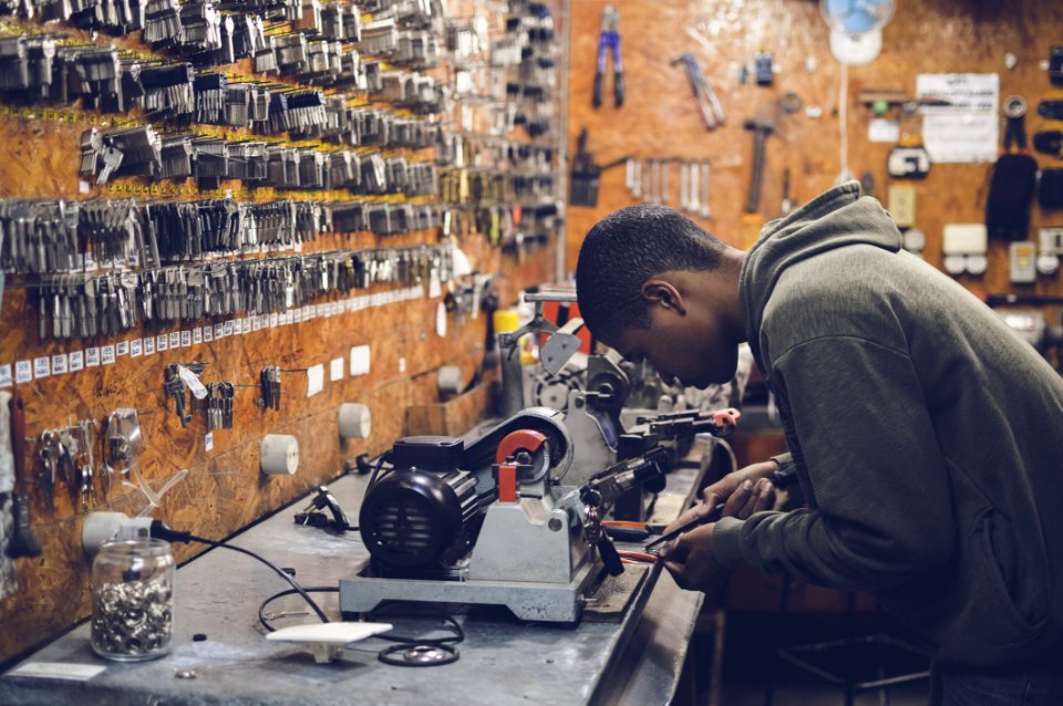 Man In Grey Hoodie Jacket Holding Black Metal Near White Socket Power Supply