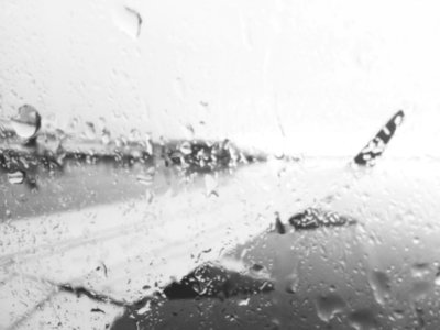 Airplane Wing Through Rainy Window