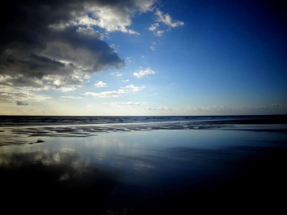 Selective Color Photography Of Ocean Overlooking The Horizon Under Blue Sky During Daytime