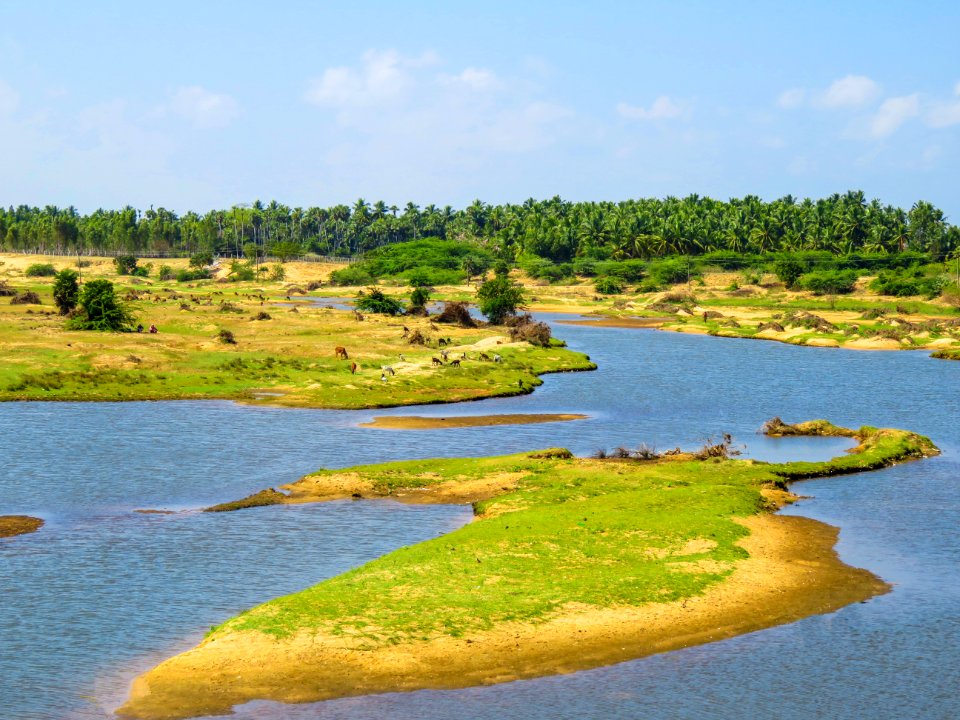 Green Grass Field Island Under Blue Sky During Daytime