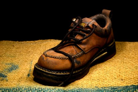 Brown And Black Leather Work Boots On Brown Surface photo