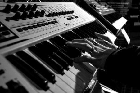 Person Playing Electric Piano In Grayscale Photo photo