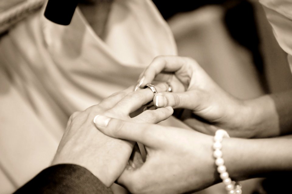 Person Putting Ring On Another Person In Grayscale Photography